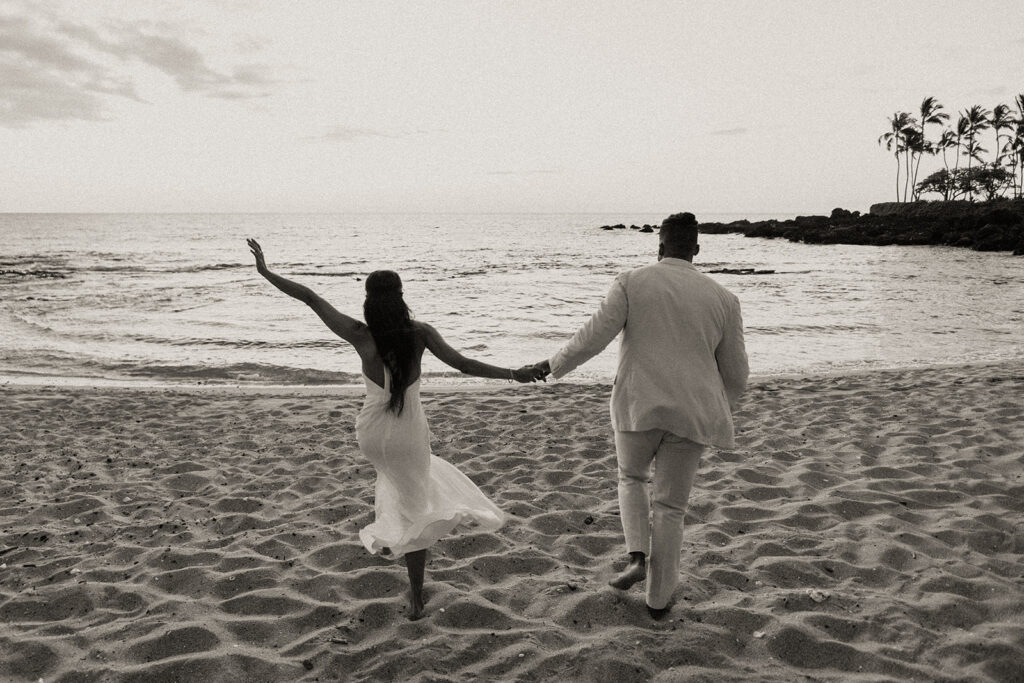 Hawaii Elopements photo of bride and groom running on the beach